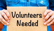 Sign that says 'Volunteers Needed'