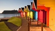 Row of multi colour beach huts by the coast