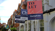 'To let' signs in front of a row of terrace houses