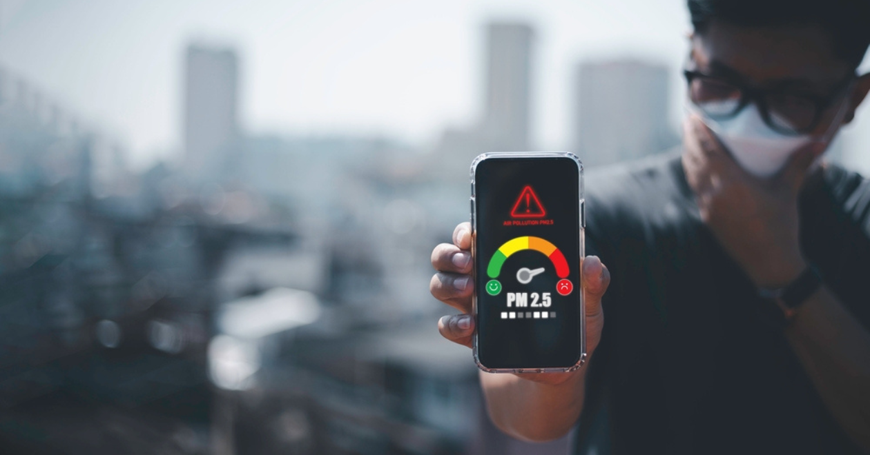 man scanning the weather on his mobile phone