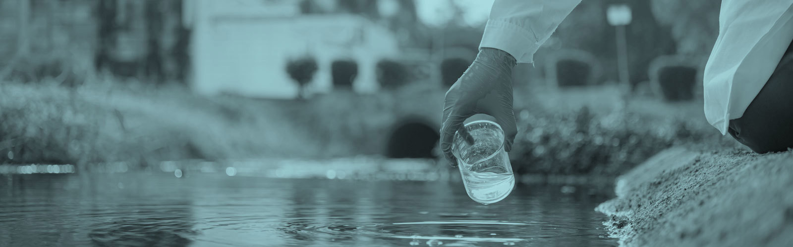 Person collecting water samples for analysis